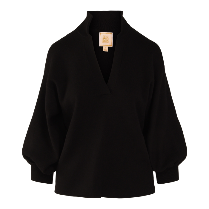 The Lolli Sweater is a black tunic-style long-sleeve blouse in soft viscose knit with a wide V-neck, loose fit, and gathered cuffs, shown on a plain white background.