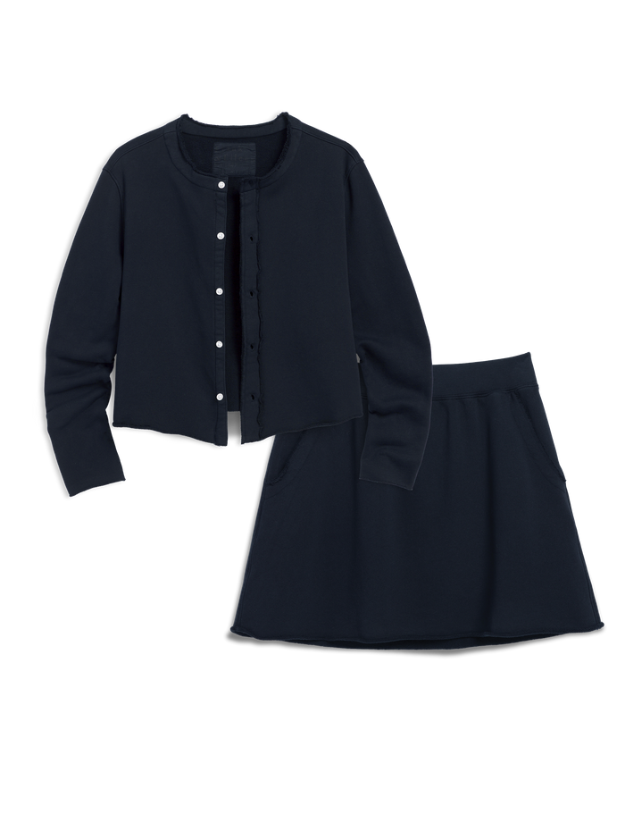 Navy blue outfit with jacket and skirt on a white background