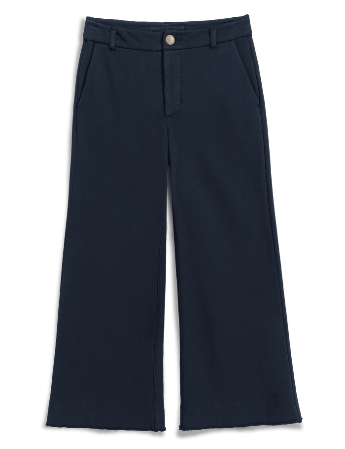A pair of dark navy blue cropped wide-leg trousers with a single button closure at the waist, displayed flat against a solid green background.