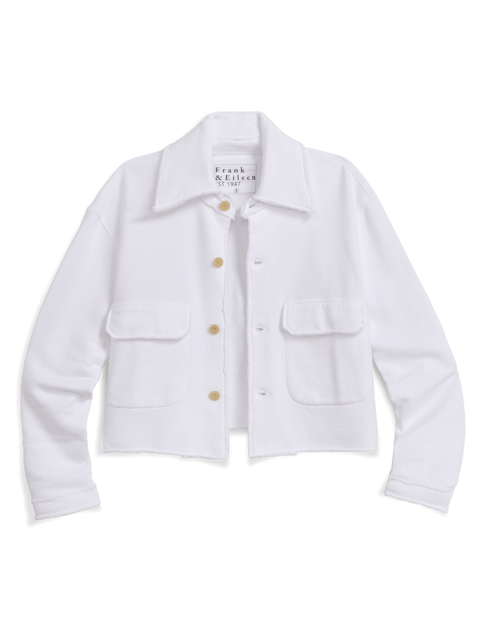 A white cropped jacket with a pointed collar, gold-tone buttons, and two front flap pockets, shown against a solid black background. The brand name 'Frank & Eileen' is visible on the inner neck label.
