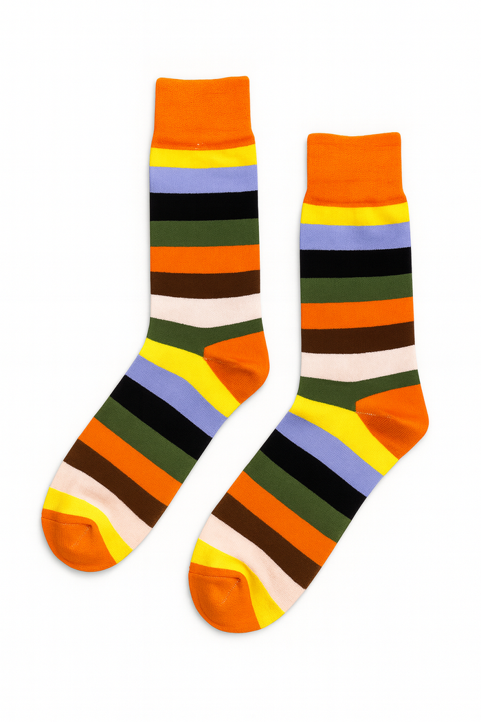 Amber Pine socks styled on neutral surface showing full amber and olive stripe pattern