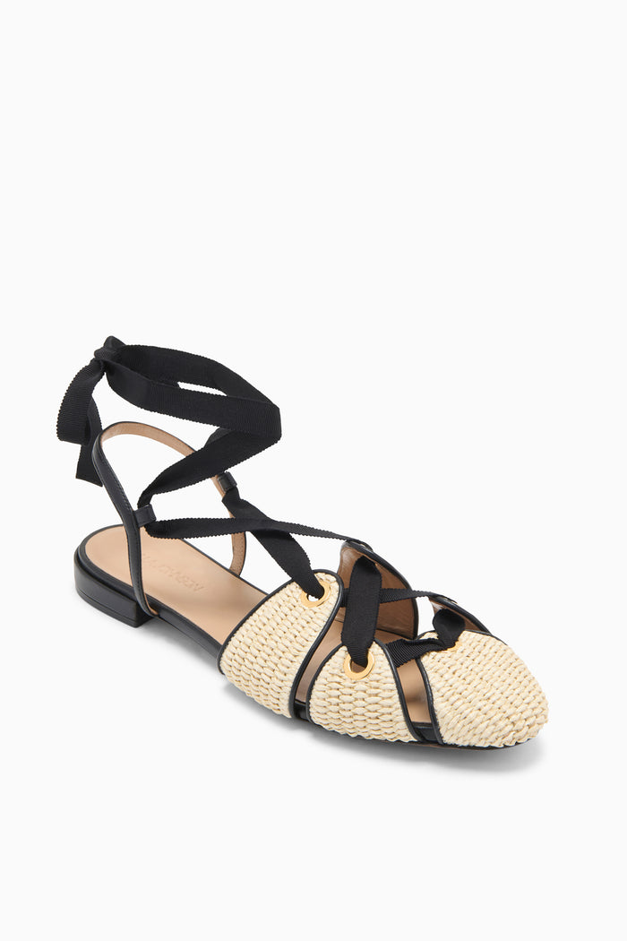 Sand Raffia Designer Flat with Gold Eyelets and Black Grosgrain Bow - Three-Quarter View | Ulla Johnson
