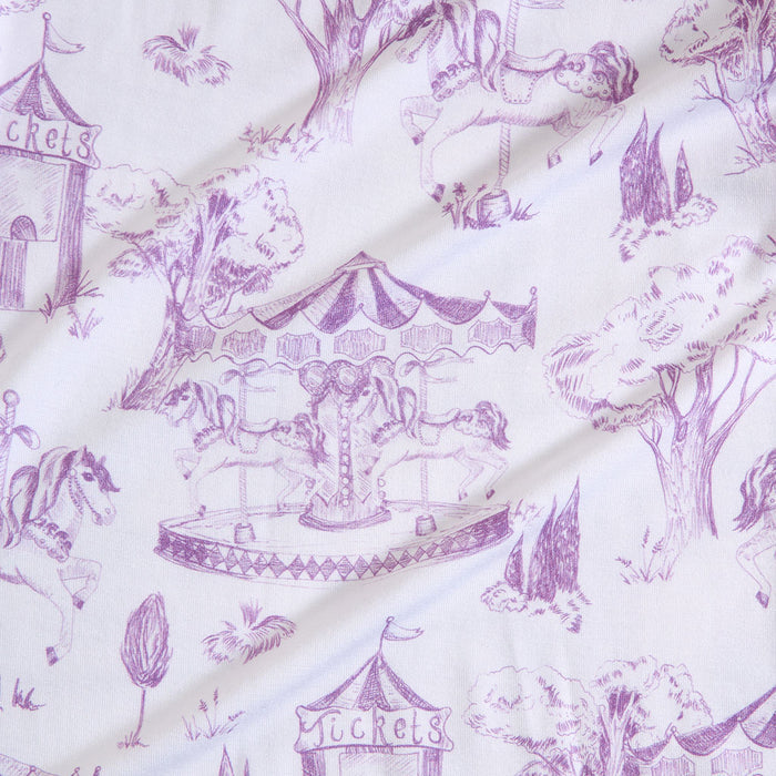 Carnival-themed fabric with purple prints on a white background