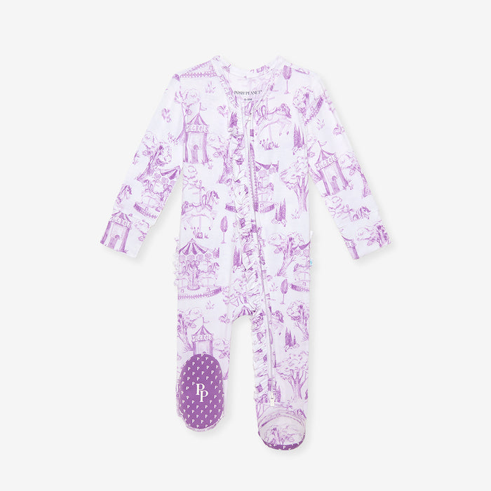 Purple children's onesie with castle pattern on a white background