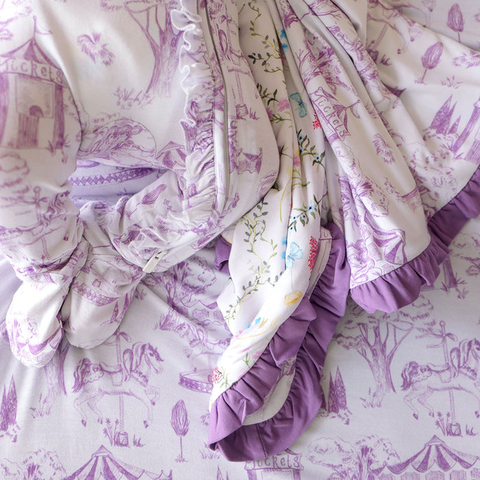 Purple and white patterned fabric with ruffled edges on a matching background