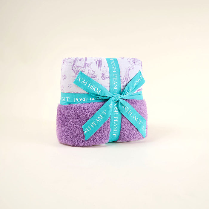 Purple blanket with a blue ribbon on a light beige background