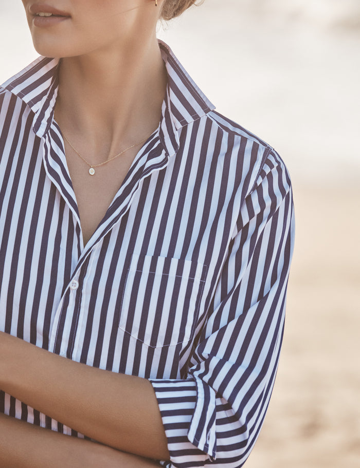 Person wearing a striped shirt with a blurred background