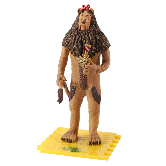 A collectible action figure of the the Cowardly Lion from The Wizard of Oz, standing on a yellow brick road base against a plain white background.