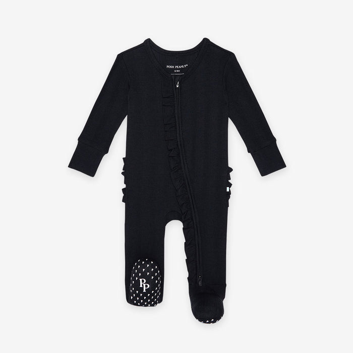 Black baby onesie with ruffles on a white background