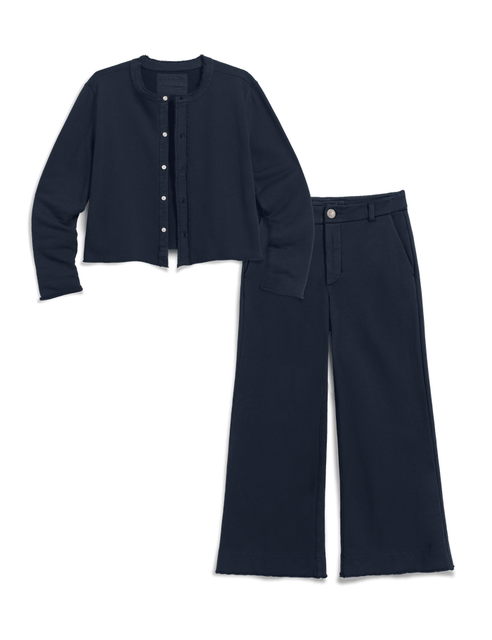 A two-piece navy blue outfit set consisting of a cropped button-front cardigan and matching wide-leg trousers, displayed on a clean white background.