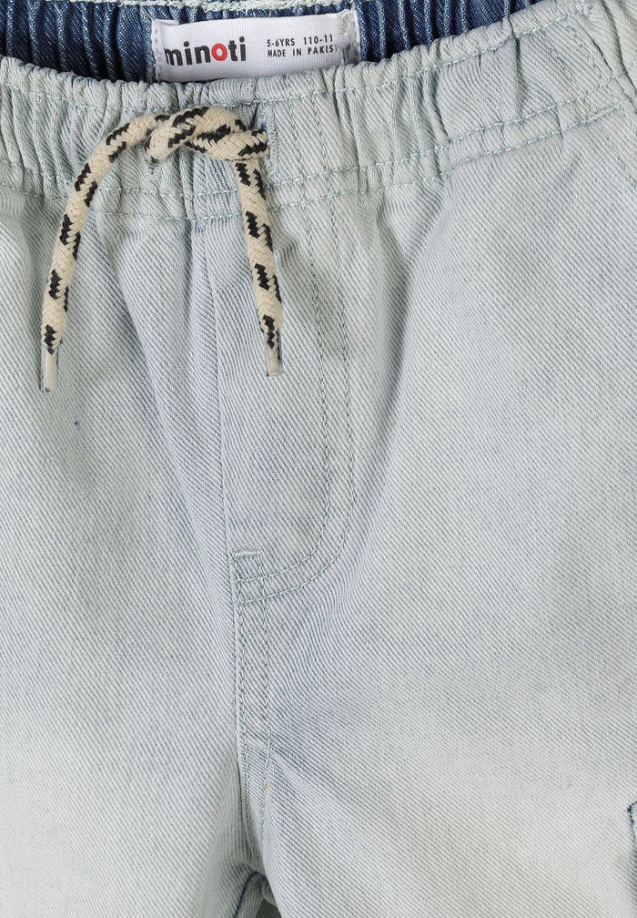 Detail of light blue denim combat shorts with elasticated waistband and drawstring.