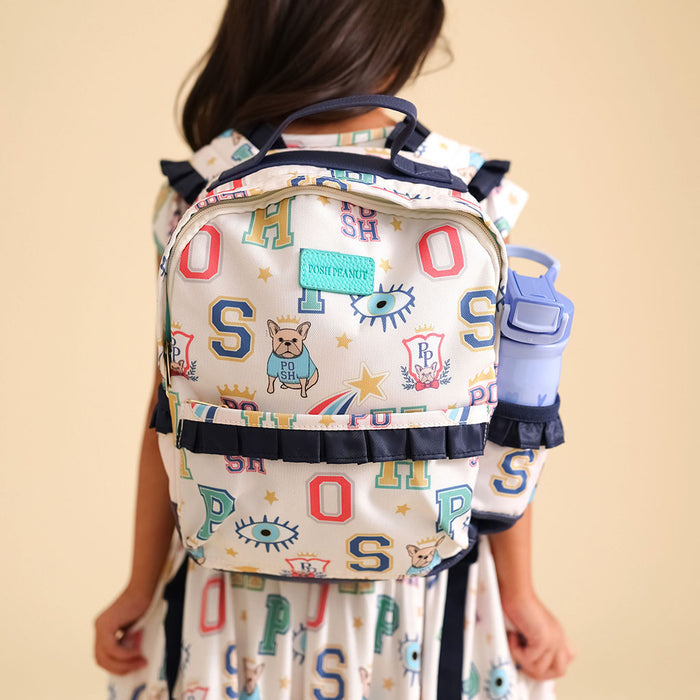Backpack with colorful letter pattern worn by a person against a beige background