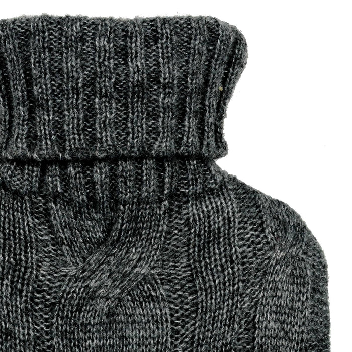 Close up of a dark grey cable design knitted cover on a hot water bottle