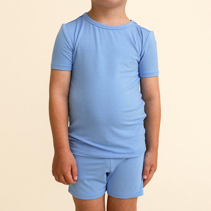 Close-up of a child wearing the Chatham Blue Classic Pajama Short Set's short-sleeve top and shorts.