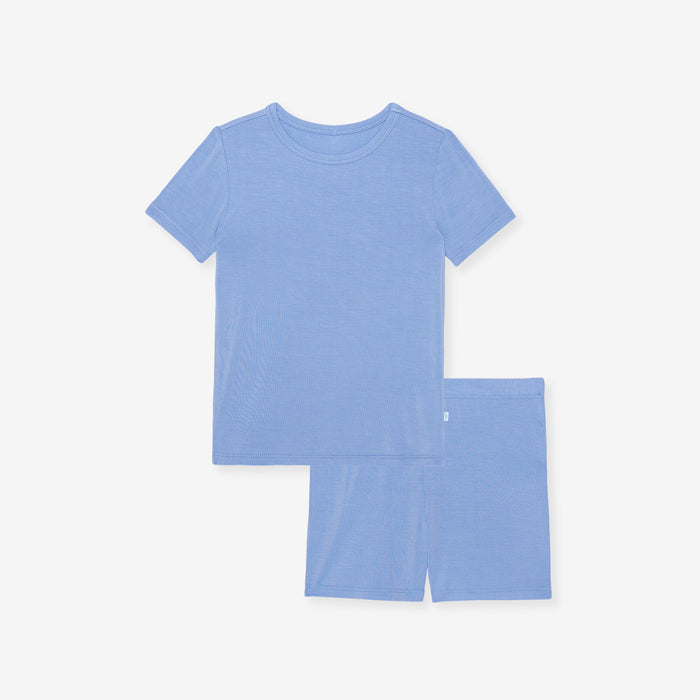 Posh Peanut Chatham Blue pajama top laid flat, showing the short-sleeve style in solid blue.