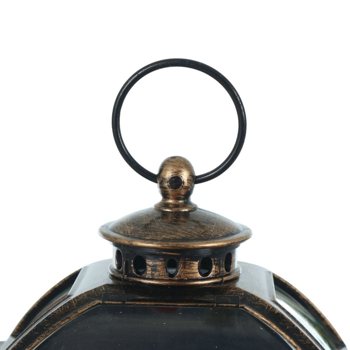 Bronze lantern with a black handle on a white background