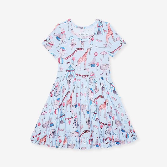 Children's dress with circus-themed print on a light blue background