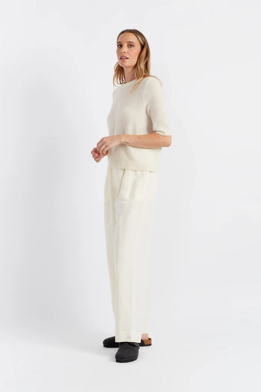 Woman wearing a white outfit on a white background