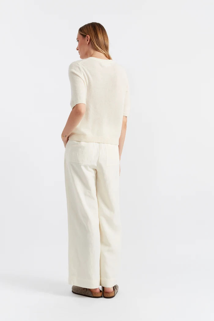 Woman wearing a white outfit on a white background