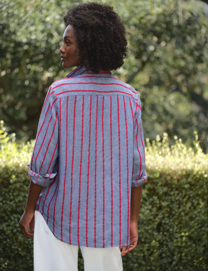 Woman wearing a blue and red striped shirt in an outdoor setting
