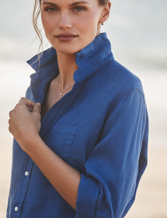 Woman wearing a blue shirt against a neutral background