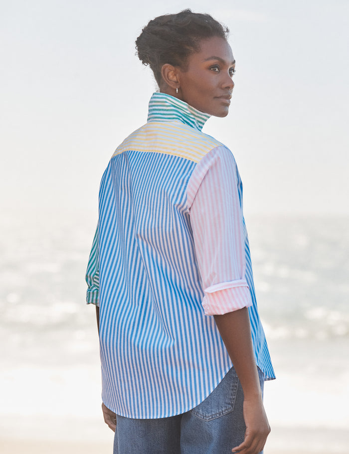 Woman wearing a colorful striped shirt with a blurred background
