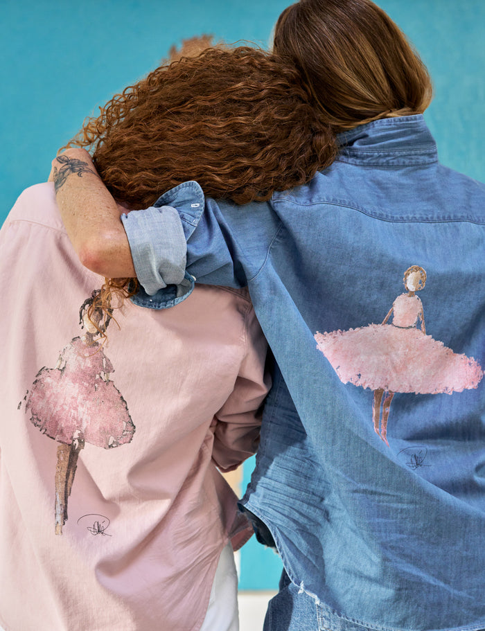 Two people wearing jackets with pink ballerina designs against a blue background