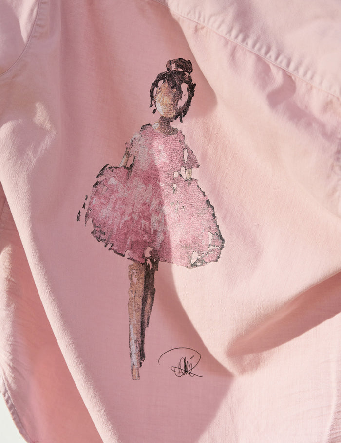 Embroidered pink dress on a pink fabric background