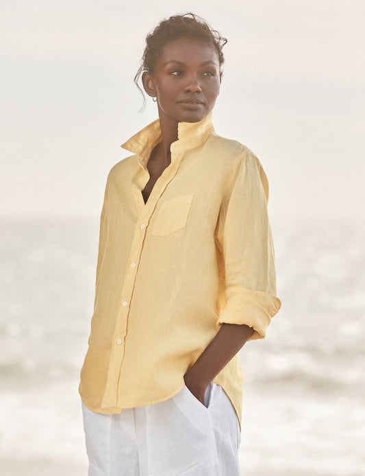 Woman wearing a yellow shirt with a blurred background