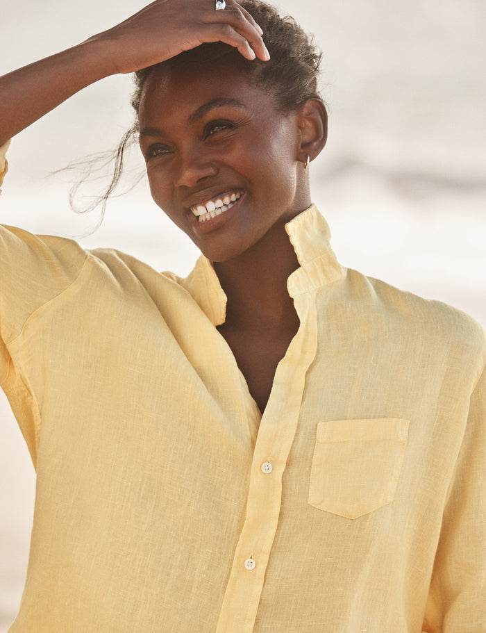 Woman wearing a yellow shirt with a blurred background