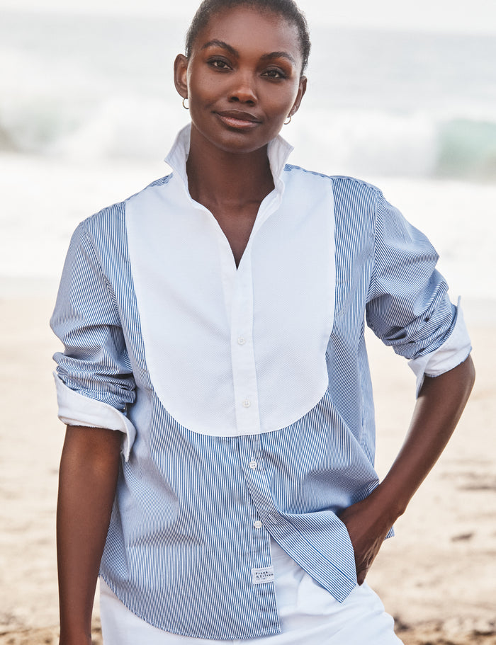 Woman wearing a blue and white striped shirt on a beach