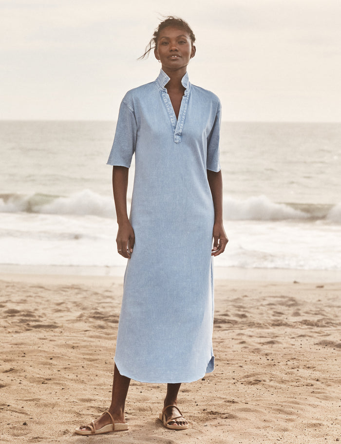 Woman wearing a light blue dress on a beach