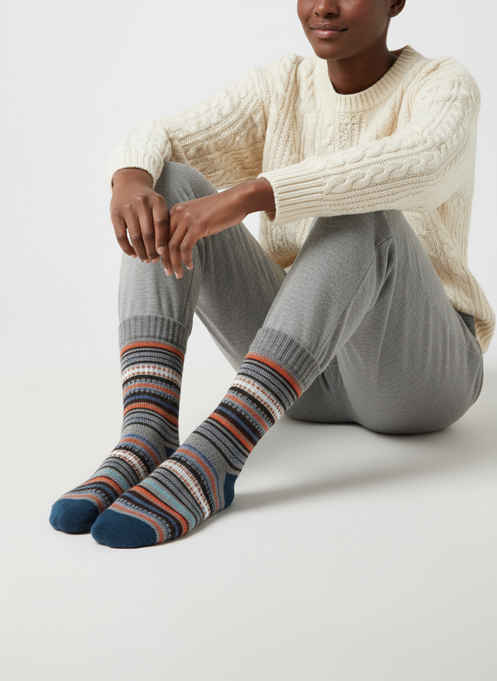 Frost Loom socks flat lay showing cool grey, navy, and orange heritage wool-blend stripe knit