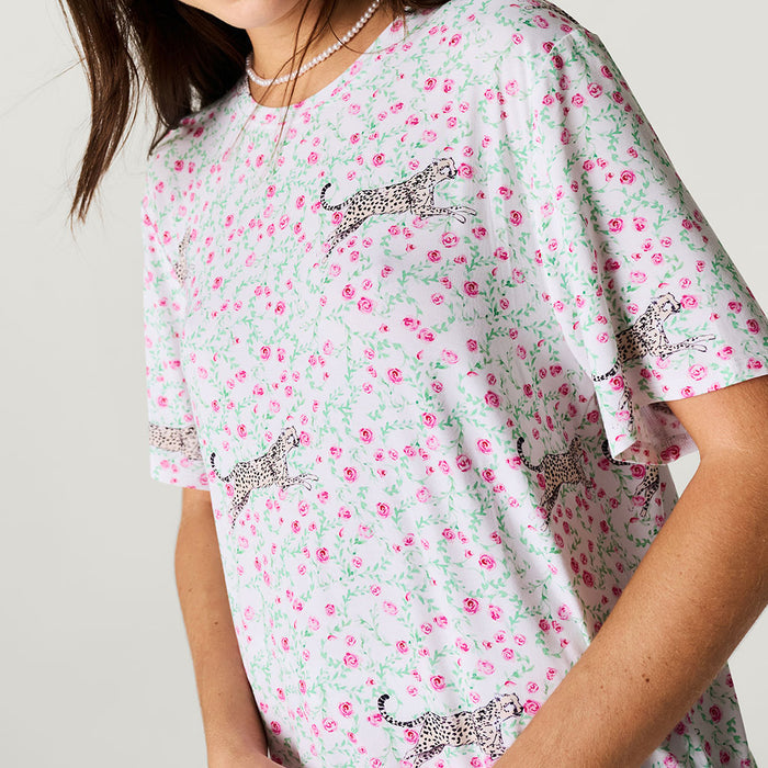 Floral patterned shirt with animal designs on a plain background