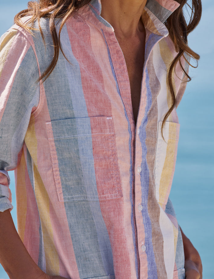 Person wearing a colorful striped shirt with a blurred background