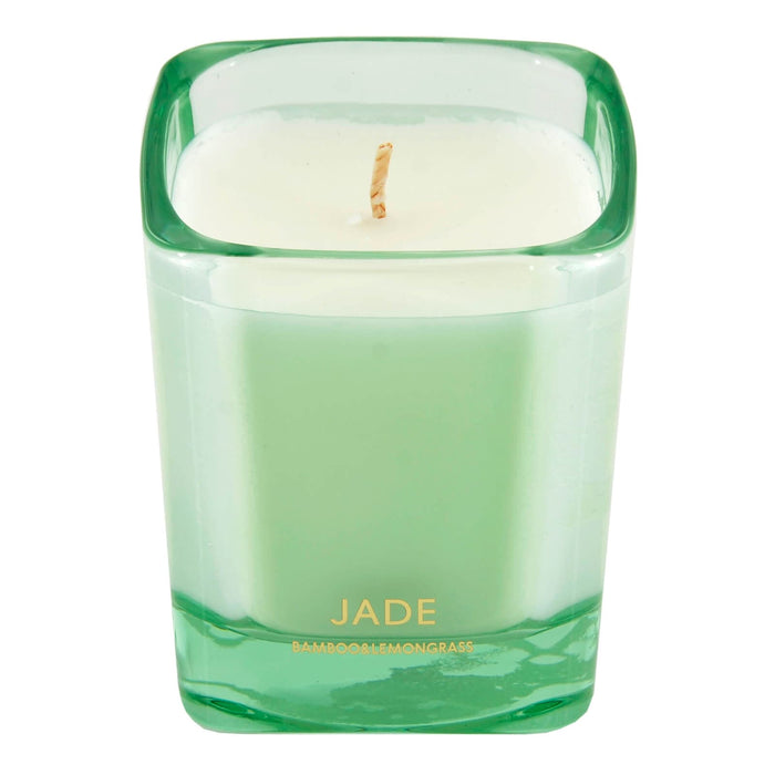 Green candle in a glass container with 'Jade' branding on a white background