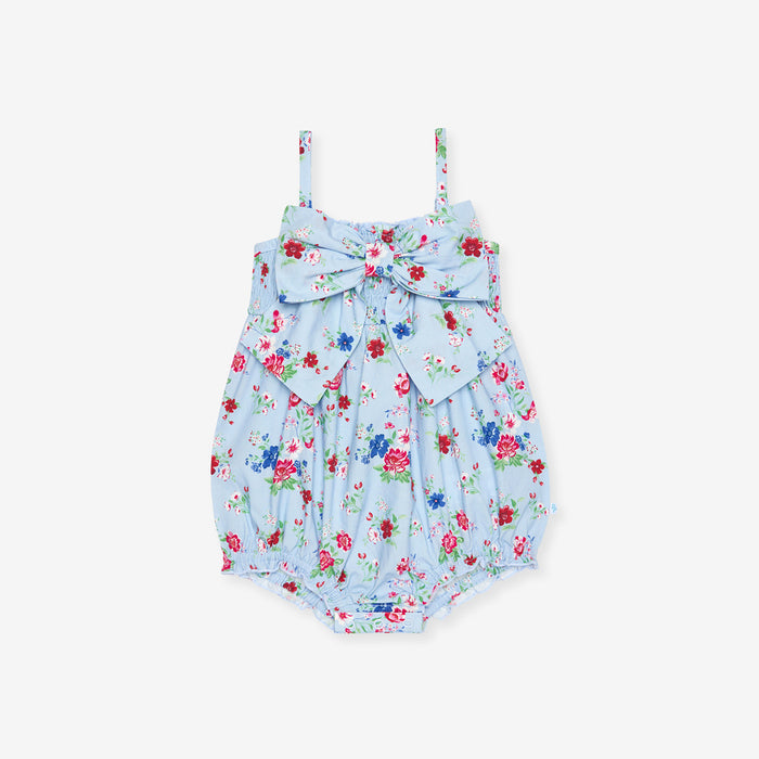 Floral baby romper with a bow on a white background