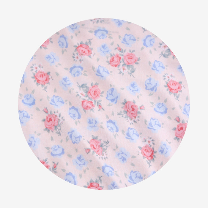 Floral patterned fabric with pink and blue flowers on a light background