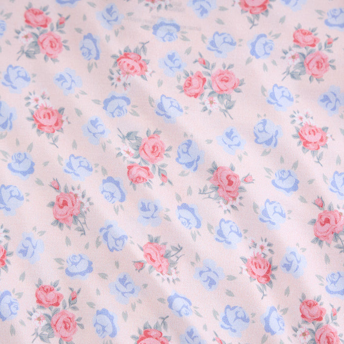 Floral pattern with pink and blue flowers on a light background