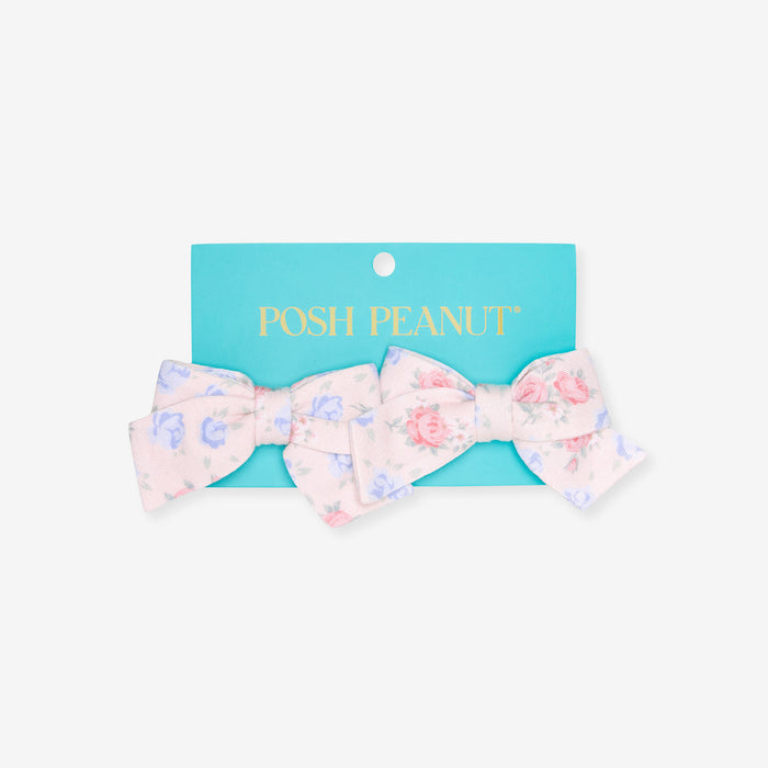 Floral bow hair clip on a Posh Peanut branded card against a white background