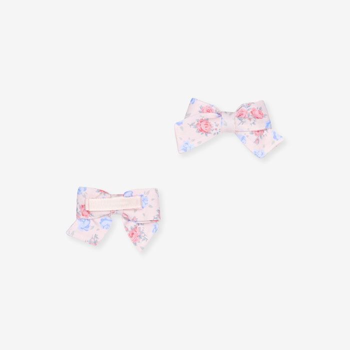 Two floral hair bows on a white background
