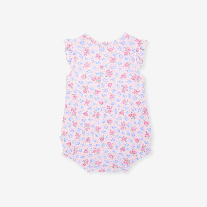 Floral patterned baby romper on a white background