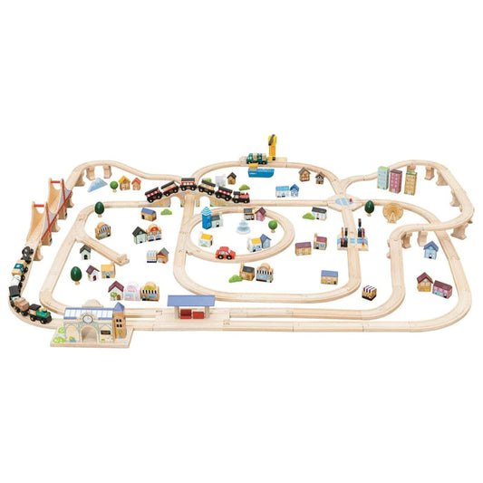 Wooden train set with tracks and small buildings on a white background