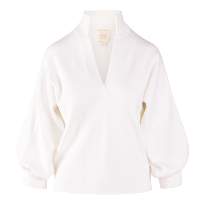 The Lolli Sweater is a sustainable women’s tunic featuring a white long-sleeve design with a deep V-neck, wide cuffs, stand collar, and relaxed fit—effortlessly stylish on a plain background.