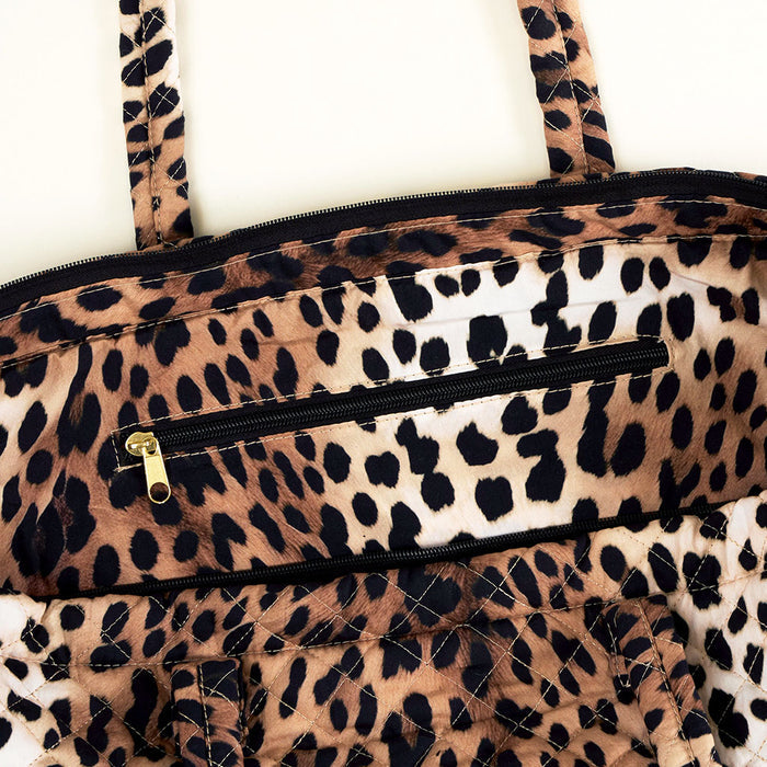 Leopard print bag with inner side zipper on a white background