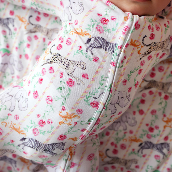 Close-up of a baby's outfit with animal and floral pattern