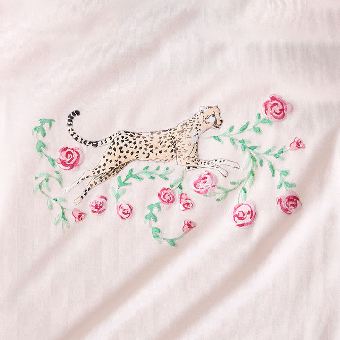 Embroidered cheetah and flowers on a light pink fabric background