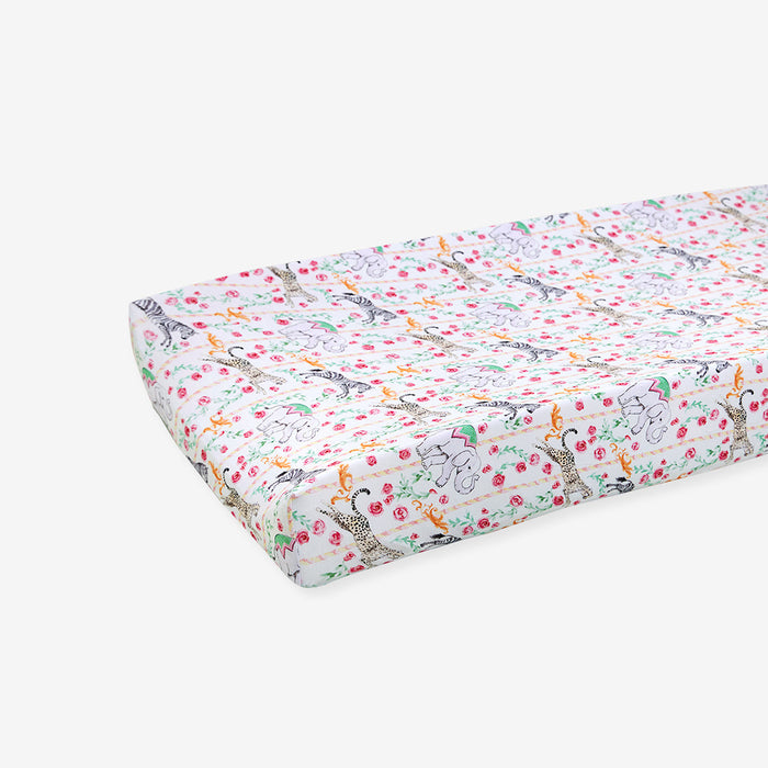 Floral and animal patterned crib sheet on a white background