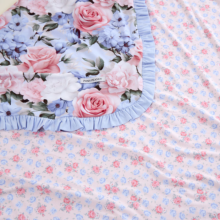 Floral fabric with pink and blue flowers and ruffled edge