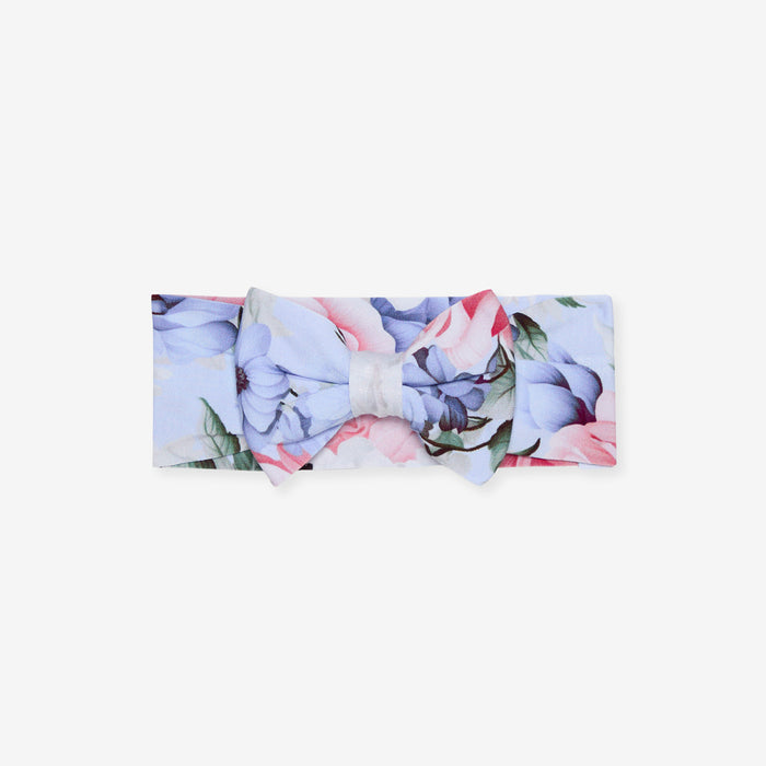 Floral headband with a bow on a light gray background